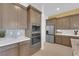 Modern kitchen featuring sleek cabinets, stainless steel appliances, and a stylish backsplash at 5095 E Long Leaf Ct, Pahrump, NV 89061