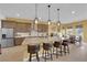 Modern kitchen with granite countertops, stainless steel appliances, and stylish pendant lighting at 5095 E Long Leaf Ct, Pahrump, NV 89061