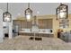 Well-lit kitchen with stainless steel appliances and a spacious island featuring overhead pendant lights at 5095 E Long Leaf Ct, Pahrump, NV 89061