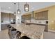 Bright kitchen featuring a large island with seating, and sleek, stainless steel appliances at 5095 E Long Leaf Ct, Pahrump, NV 89061