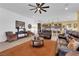 Open-concept living room with a leather sofa, accent chairs, and a cozy atmosphere at 5095 E Long Leaf Ct, Pahrump, NV 89061