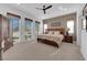 Spacious main bedroom featuring neutral tones, plush carpet, and large windows at 5095 E Long Leaf Ct, Pahrump, NV 89061