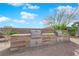 The outdoor kitchen has stainless steel grills and counter space for entertaining at 5095 E Long Leaf Ct, Pahrump, NV 89061