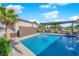 Backyard pool with a covered dining and grilling area, a water feature, desert landscaping at 5095 E Long Leaf Ct, Pahrump, NV 89061