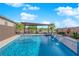 Backyard pool with a covered dining and grilling area, a water feature, desert landscaping at 5095 E Long Leaf Ct, Pahrump, NV 89061