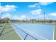 Multiple outdoor tennis courts, with green and blue surfaces, surrounded by a fence and community landscaping at 5095 E Long Leaf Ct, Pahrump, NV 89061