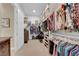 Large walk-in closet with custom shelving, hanging racks, and ample storage space at 5095 E Long Leaf Ct, Pahrump, NV 89061