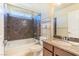 This bathroom features granite counters and a shower over tub at 5350 Tulip Hill Ave, Las Vegas, NV 89141