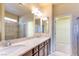 Bathroom featuring double sinks, granite counters, shower, and walk-in closet at 5350 Tulip Hill Ave, Las Vegas, NV 89141