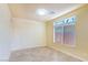 Bright bedroom featuring neutral walls, a large window, and tile flooring at 5350 Tulip Hill Ave, Las Vegas, NV 89141