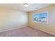 This is a bedroom featuring neutral walls, carpet, and a bright window at 5350 Tulip Hill Ave, Las Vegas, NV 89141