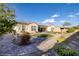 Spacious backyard featuring lush landscaping, brick paver pathways, and a well-maintained exterior at 6333 Orto Vaso Ave, Las Vegas, NV 89131