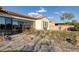 Inviting backyard with a stone-paved path, mature plants, and a bright sunroom at 6333 Orto Vaso Ave, Las Vegas, NV 89131