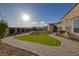 Sunny backyard with manicured lawn, brick pathway, and a charming garden area perfect for relaxation and outdoor enjoyment at 6333 Orto Vaso Ave, Las Vegas, NV 89131