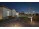 Charming backyard with a brick path, well-maintained landscaping, and subtle outdoor lighting for evening enjoyment at 6333 Orto Vaso Ave, Las Vegas, NV 89131