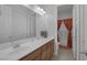 Bathroom featuring dual sinks, a large mirror, and a doorway to the shower/tub at 6333 Orto Vaso Ave, Las Vegas, NV 89131
