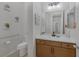 Well-lit bathroom with a modern vanity, ample counter space, and a decorative mirror at 6333 Orto Vaso Ave, Las Vegas, NV 89131