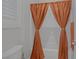 Cozy bathroom featuring an orange shower curtain and neutral colors at 6333 Orto Vaso Ave, Las Vegas, NV 89131