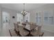 Bright dining room with stylish chandelier and seating for eight at 6333 Orto Vaso Ave, Las Vegas, NV 89131