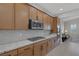 Kitchen featuring stainless steel appliances, wood cabinets and beautiful granite countertops at 6333 Orto Vaso Ave, Las Vegas, NV 89131