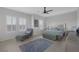 Spacious main bedroom featuring neutral walls, plenty of natural light, and a comfortable chaise lounge at 6333 Orto Vaso Ave, Las Vegas, NV 89131