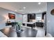 Modern kitchen with dark cabinets, an island with seating, and a dining table with chairs at 649 Tranquil Jade St, Las Vegas, NV 89138