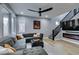 Comfortable living room featuring a modern fan, plush sectional, and electric fireplace at 649 Tranquil Jade St, Las Vegas, NV 89138