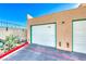 Garage with a white door, accented by desert landscaping, against a clear blue sky at 6750 Del Rey Ave Ave # 226, Las Vegas, NV 89146