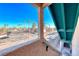 A view from the upstairs landing overlooking a sunny street with palm trees and parked cars at 6750 Del Rey Ave Ave # 226, Las Vegas, NV 89146