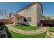 Beautiful backyard with an extended covered patio, artificial grass, and a lovely stone pathway at 7018 Hunts Corner St, Las Vegas, NV 89166