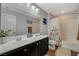 Well-appointed bathroom with double sinks, a large mirror, and a shower-tub combo at 7018 Hunts Corner St, Las Vegas, NV 89166