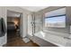 Bright bathroom featuring an enclosed glass shower and a separate soaking tub at 7018 Hunts Corner St, Las Vegas, NV 89166
