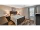Inviting bedroom with a wooden bed frame, soft lighting from lamps, and a serene ambiance for restful nights at 7018 Hunts Corner St, Las Vegas, NV 89166