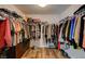 Spacious walk-in closet with ample hanging space and shelving for clothes and accessories at 7018 Hunts Corner St, Las Vegas, NV 89166