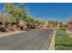 Gated community entrance with lush landscaping, offering security and curb appeal at 7018 Hunts Corner St, Las Vegas, NV 89166