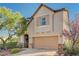 Charming two-story home features a neutral palette, well-manicured landscaping, and a two-car garage at 7018 Hunts Corner St, Las Vegas, NV 89166