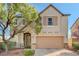 Charming two-story home features a neutral palette, well-manicured landscaping, and a two-car garage at 7018 Hunts Corner St, Las Vegas, NV 89166