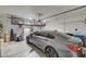 Organized garage featuring a sleek car, storage racks, and ample space for parking and storage at 7018 Hunts Corner St, Las Vegas, NV 89166
