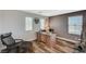 Upstairs loft converted into home office with a large desk, comfortable chair, and natural light at 7018 Hunts Corner St, Las Vegas, NV 89166
