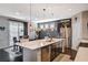 Stylish kitchen featuring a central island, stainless steel appliances, and an adjacent dining area at 7018 Hunts Corner St, Las Vegas, NV 89166