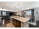 Open-concept kitchen with island, dining space, and living area provides ample space at 7018 Hunts Corner St, Las Vegas, NV 89166