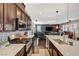 Bright, open kitchen flows into the living area, equipped with modern appliances and fixtures at 7018 Hunts Corner St, Las Vegas, NV 89166