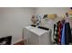 Functional laundry room featuring a washer, dryer, shelving, and ample space for organizing laundry essentials at 7018 Hunts Corner St, Las Vegas, NV 89166
