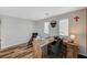 Comfortable home office with wood floors, a stylish desk, and a relaxing sitting chair at 7018 Hunts Corner St, Las Vegas, NV 89166