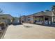 Spacious backyard with a concrete area, basketball hoop, and outdoor kitchen under a covered patio at 720 Camino La Paz, Henderson, NV 89012