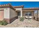 Inviting front porch with seating area and desert landscaping, leading to the front door at 720 Camino La Paz, Henderson, NV 89012