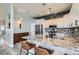 Bright kitchen with white cabinets, granite countertops, mosaic backsplash, and stainless steel appliances at 720 Camino La Paz, Henderson, NV 89012