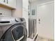 Well-equipped laundry room with modern front-load washer and dryer, plus extra storage at 720 Camino La Paz, Henderson, NV 89012