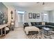 Comfortable living room with modern decor, gray sectional, decorative ladder, and light gray wood-look floors at 720 Camino La Paz, Henderson, NV 89012