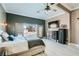 Spacious main bedroom with a ceiling fan, dresser, wall-mounted TV, safe, and French doors to the pool at 720 Camino La Paz, Henderson, NV 89012